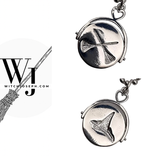 Silver tone pendant with a crossed broomstick design on one side and showing the Witch hat design on the reverse, shown on a white background, also featuring the Witch Joseph brand.