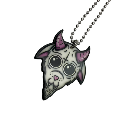 Neon pink and black Goat-shaped Baphomet pendant on a ball chain against a white background