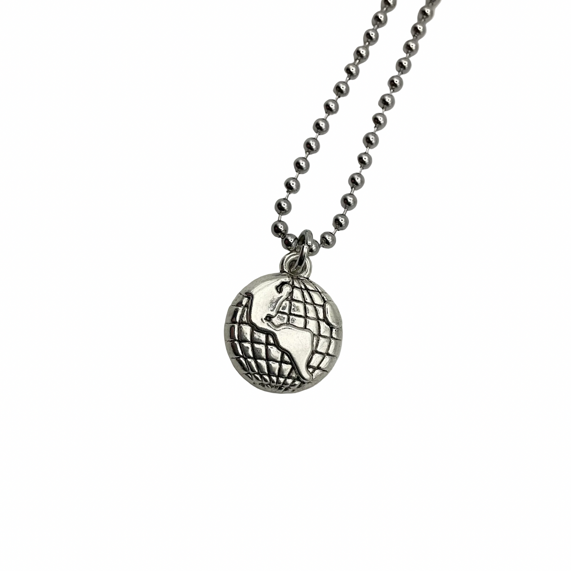 Silver tone necklace with an earth globe pendant on a white background