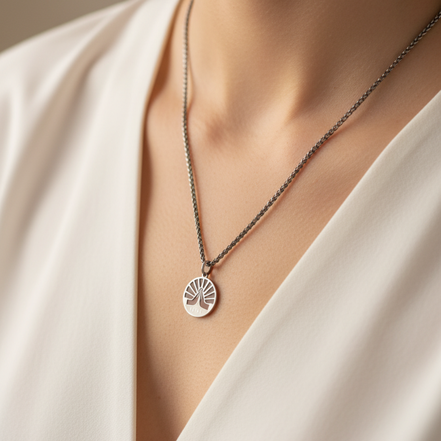 Steel Necklace with an eleven eleven pendant with praying hands…worn by a person in a white outfit.