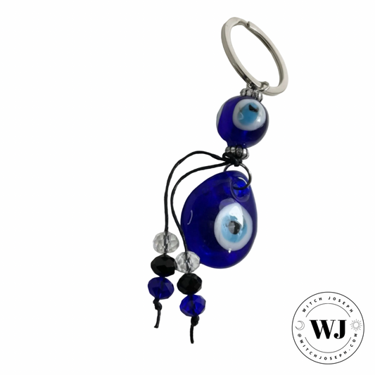 Decorative keychain with blue evil eye bead and decorative beads displayed on a white background