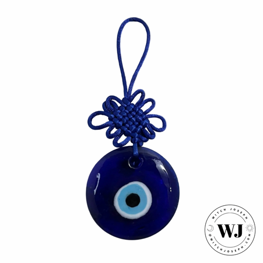 Blue evil eye charm with a white background