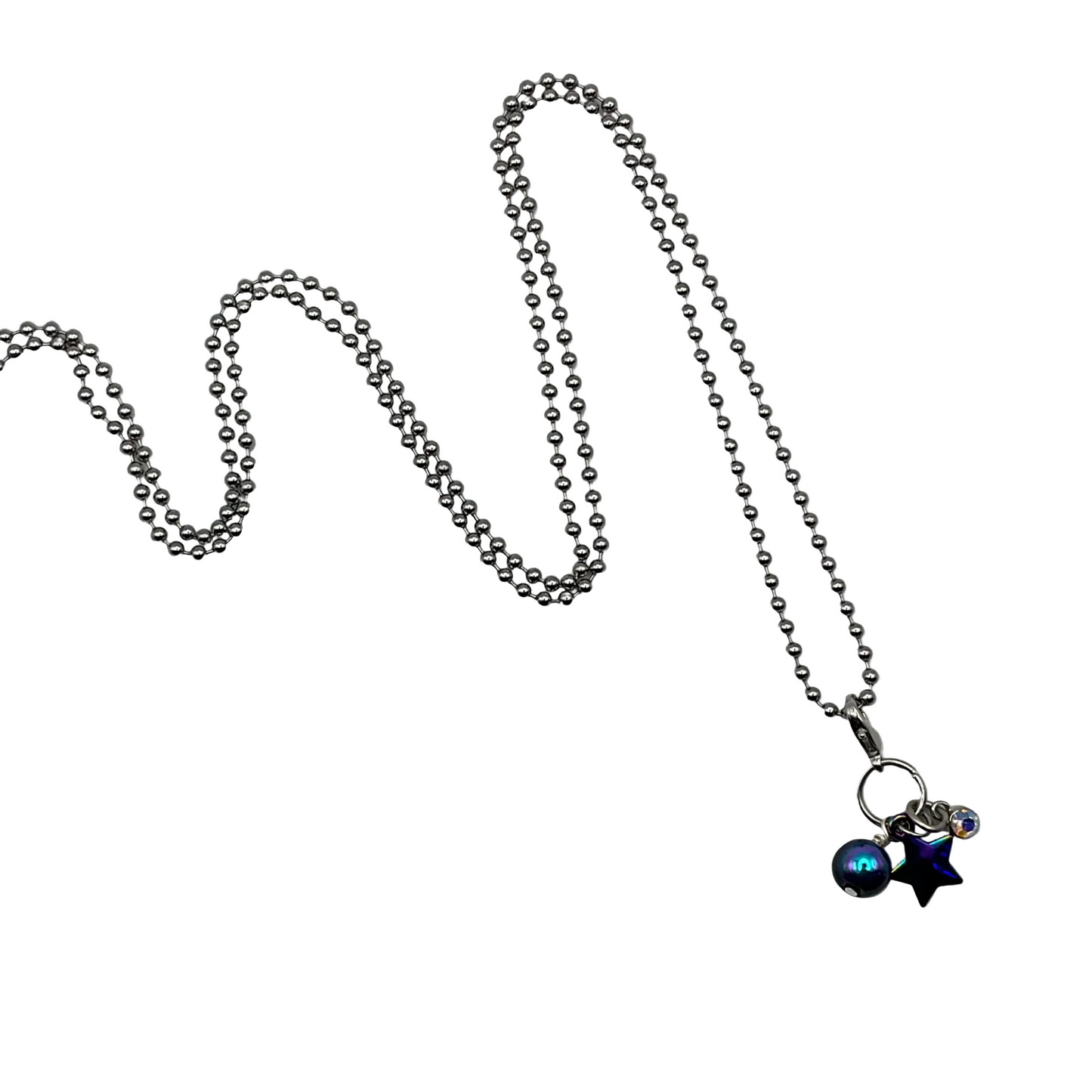 Ball chain Necklace with star-shaped pendant and a iridescent bead and a sparkly charm on a white background