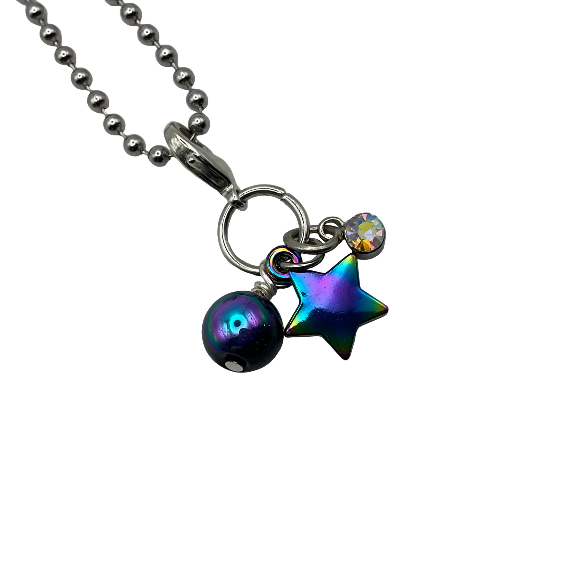 Ball chain Necklace with a star and a sparkly crystal and round multicolored bead charm on a white background