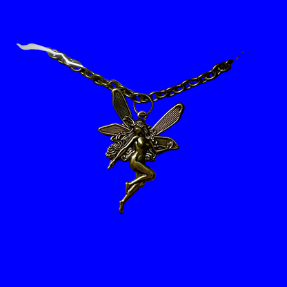 a vintage style fairy pendant in bronze tone on a chain displayed against a blue background