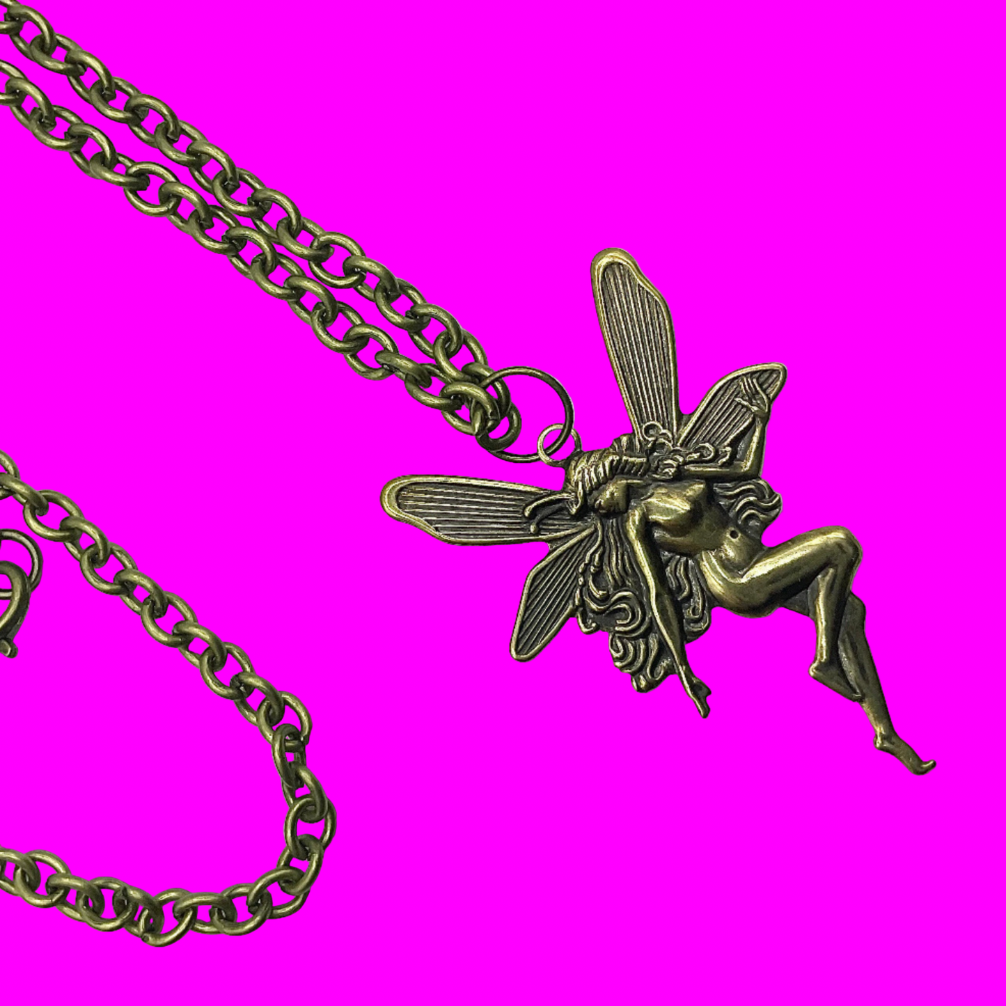 Bronze tone fairy pendant on a bronze tone chain displayed against a pink background