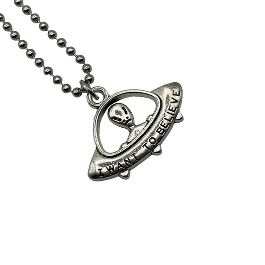 Silver necklace with a flying saucer pendant with alien featuring 'I Want to Believe' text on a white background