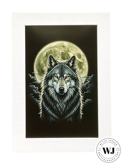 A matted art print featuring a detailed illustration of a wolf with glowing eyes set against a large full moon and dark clouds. The print is mounted in a white mat, with a circular 'WJ' Witch Joseph logo in the bottom right corner.