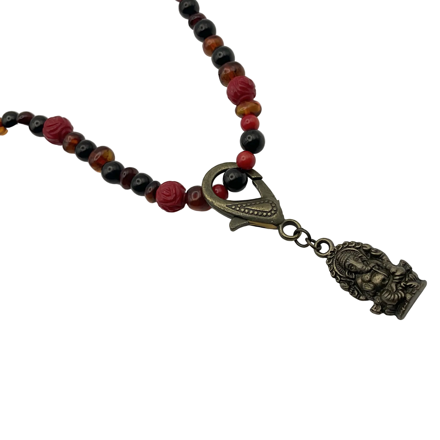 Necklace with multicolored amber jet and coral beads and a decorative bronze tone Ganesha pendant on a white background