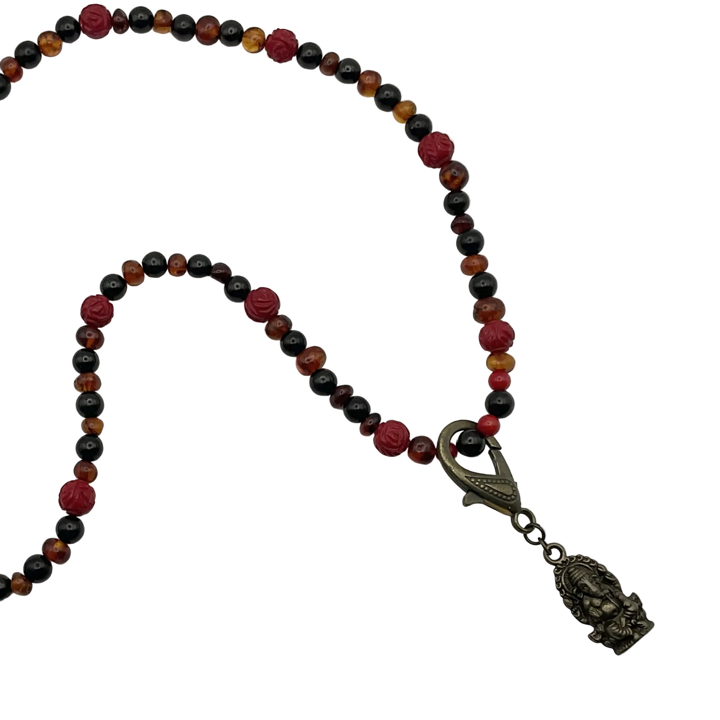 Necklace with multicolored Amber Jet and Coral beads and a decorative clasp with a bronze tone Ganesha Pendant on a white background