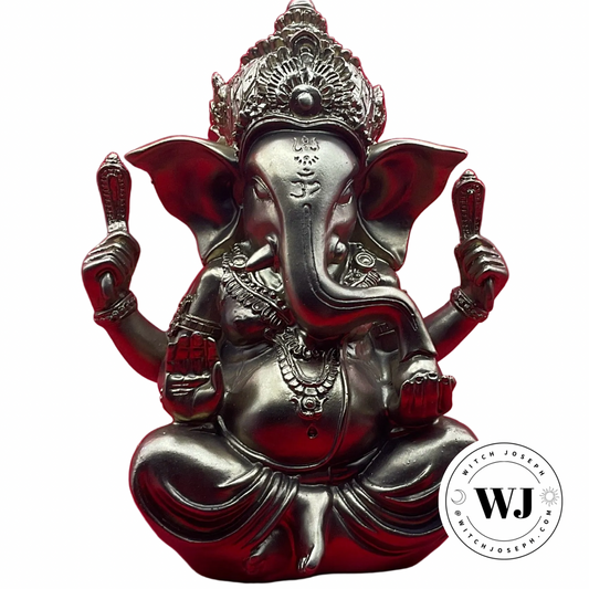 Statue of a Ganesha in gold color displayed on a white background