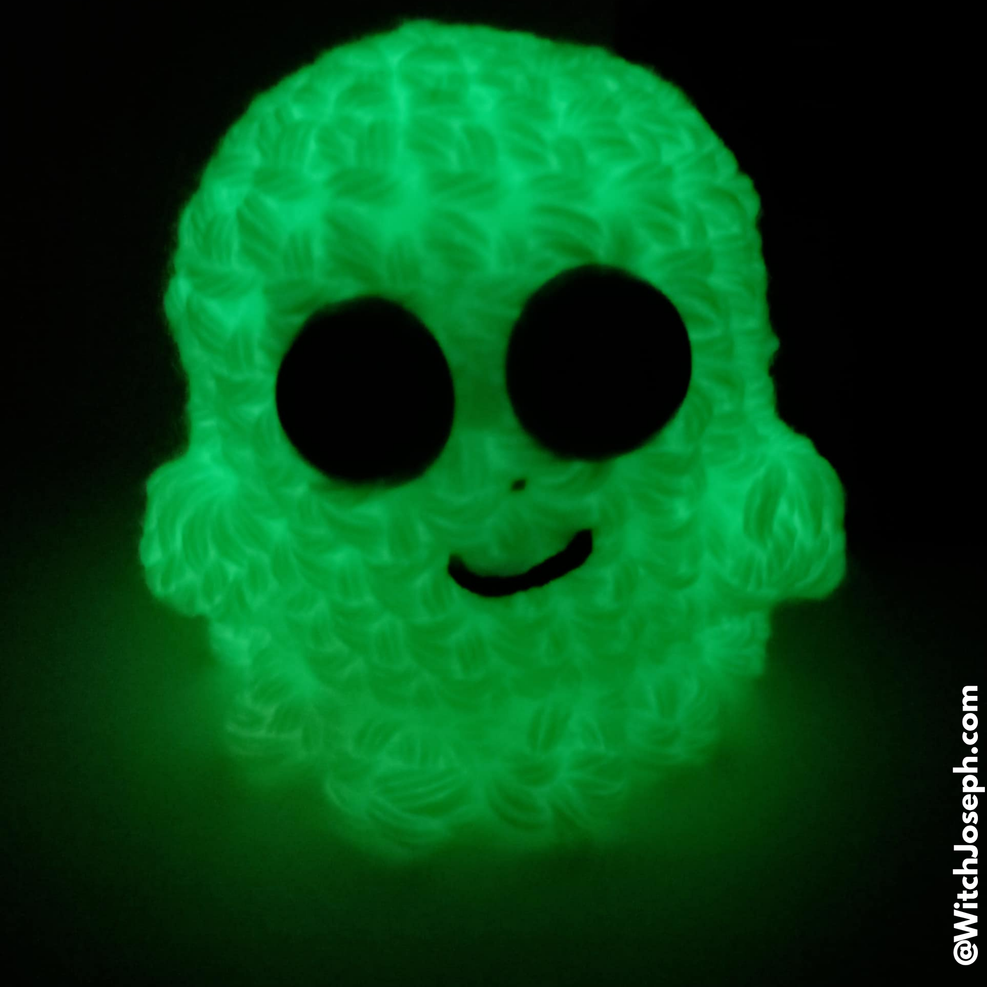Glowing ghost decoration on a black background with the Witch Joseph URL