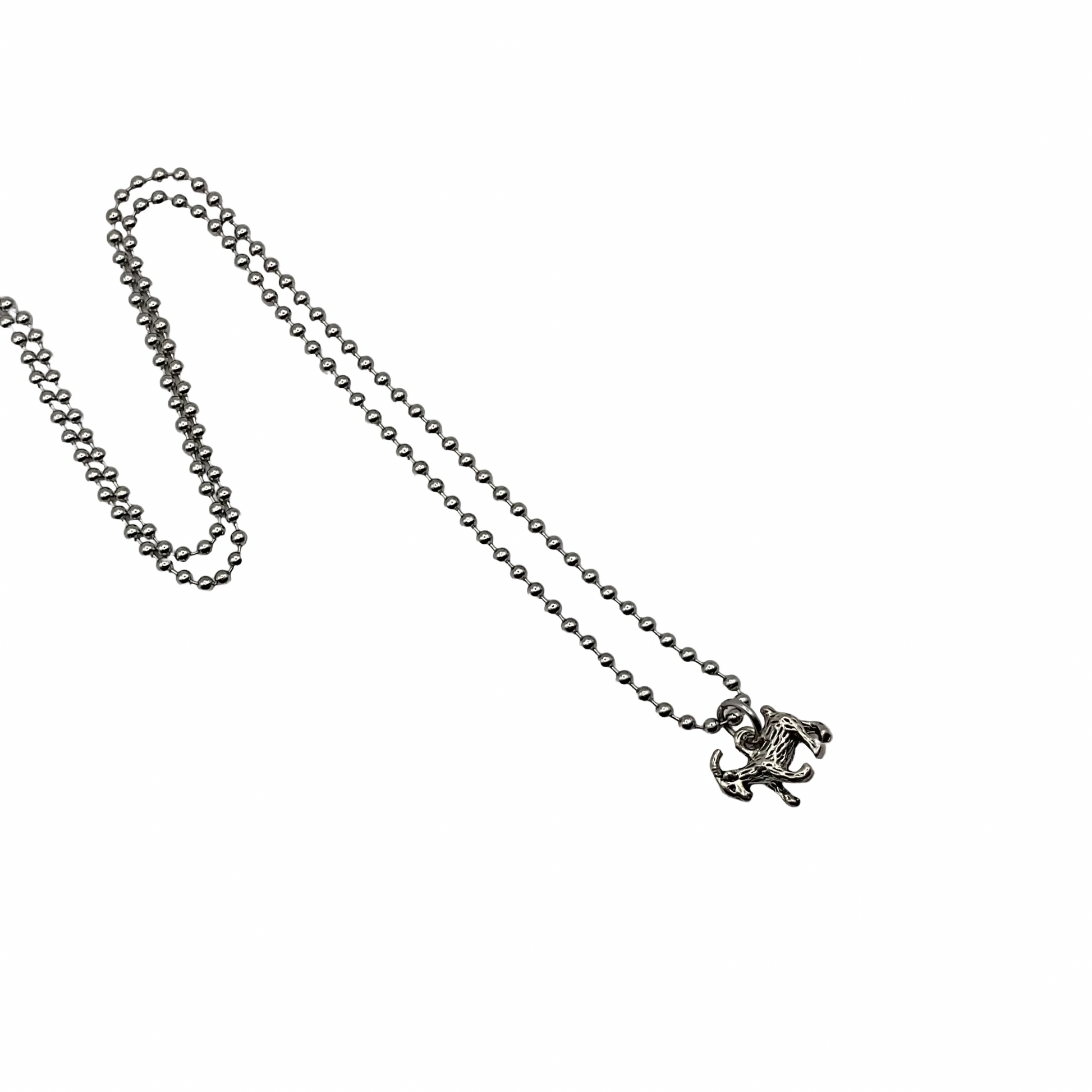 Silver tone chain necklace with a small silver tone goat pendant on a white background