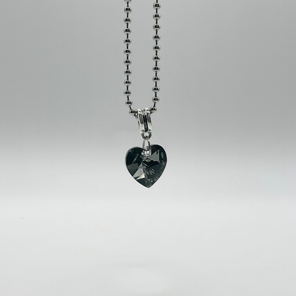 Heart-shaped gray crystal pendant on a silver tone ball chain against a white background