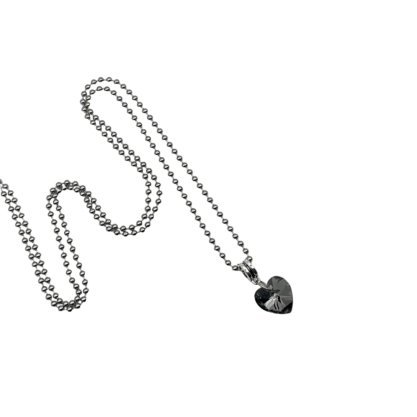 Silver tone ball chain charm necklace with a gray heart-shaped crystal pendant on a white background