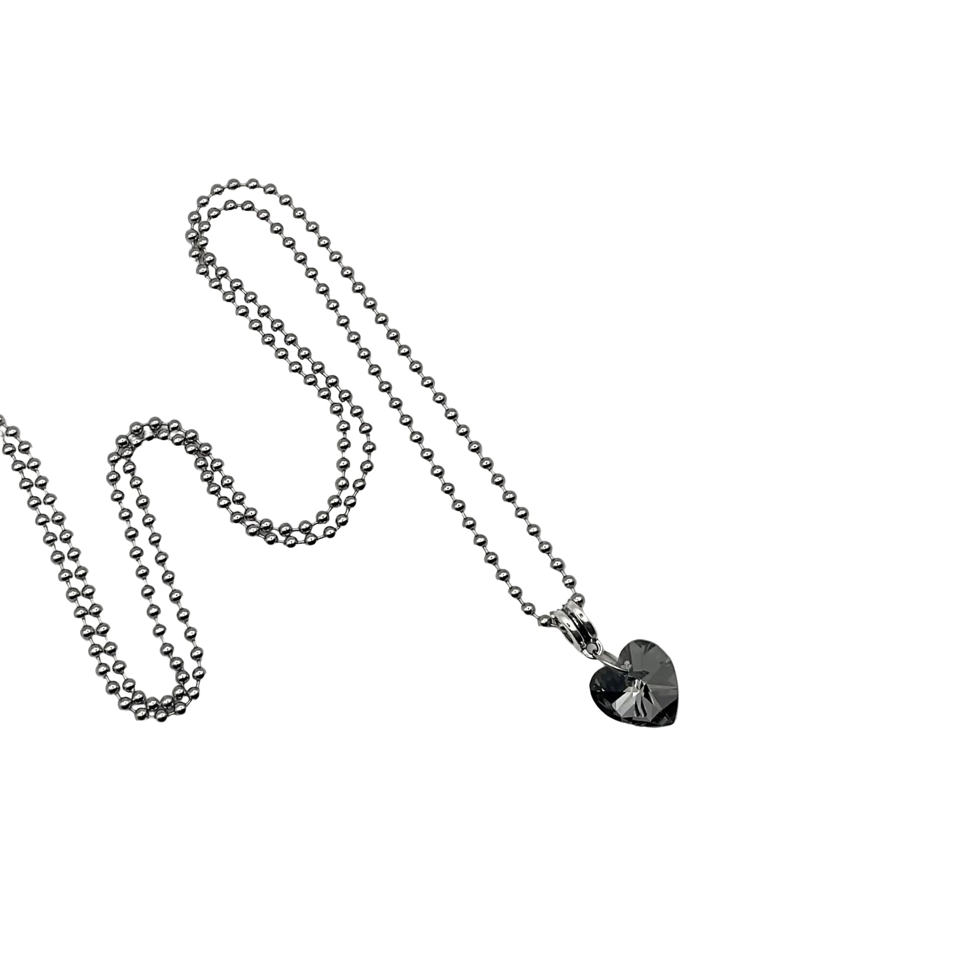 Silver tone ball chain charm necklace with a gray heart-shaped crystal pendant on a white background