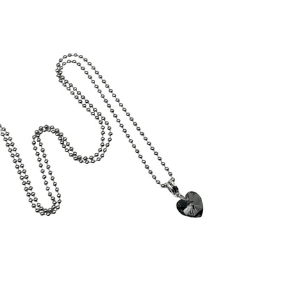 Silver tone ball chain charm necklace with a gray heart-shaped crystal pendant on a white background