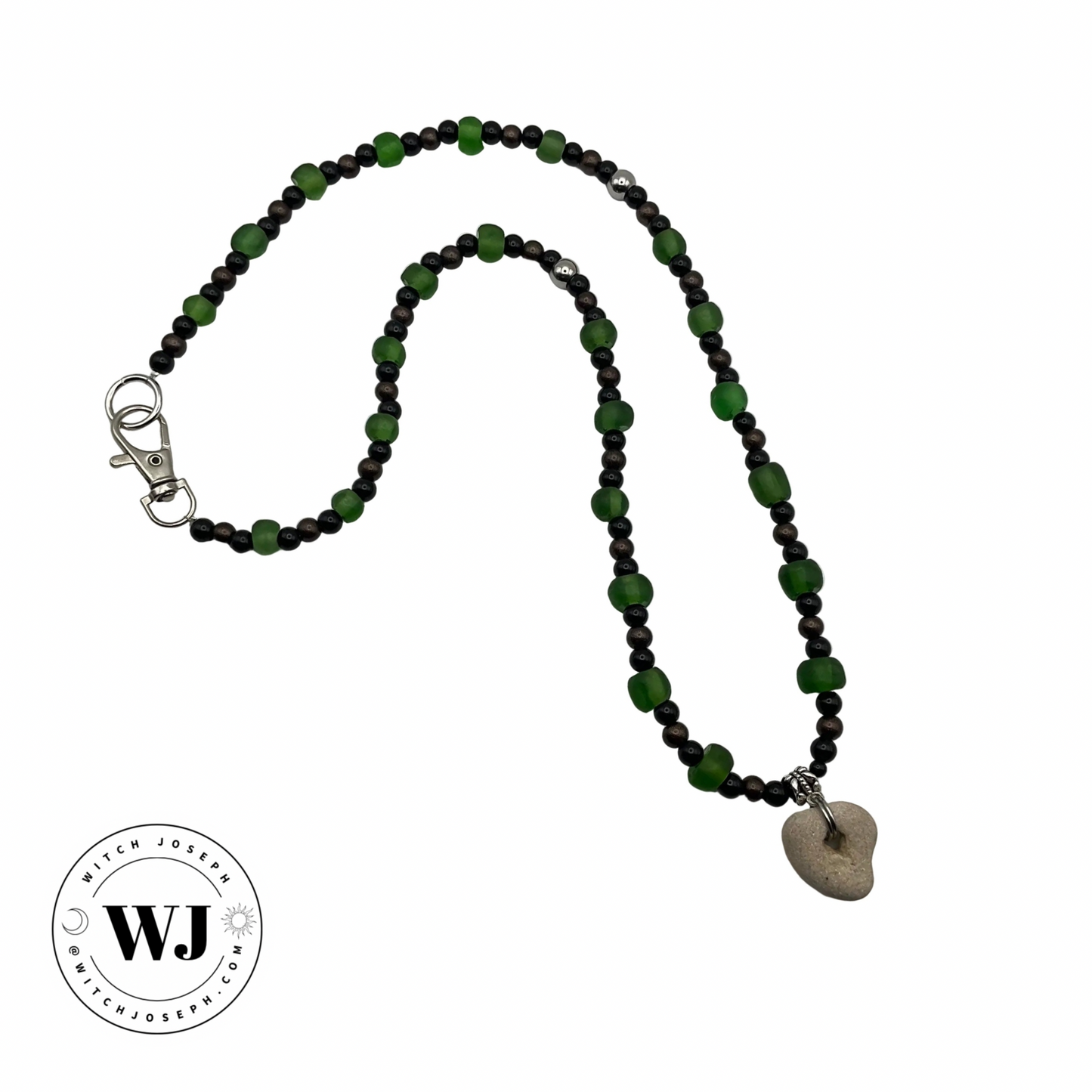 Green sea glass beads and black and copper accent beads talisman necklace with a small Holey stone pendant on a white background, featuring the brand 'WJ'.