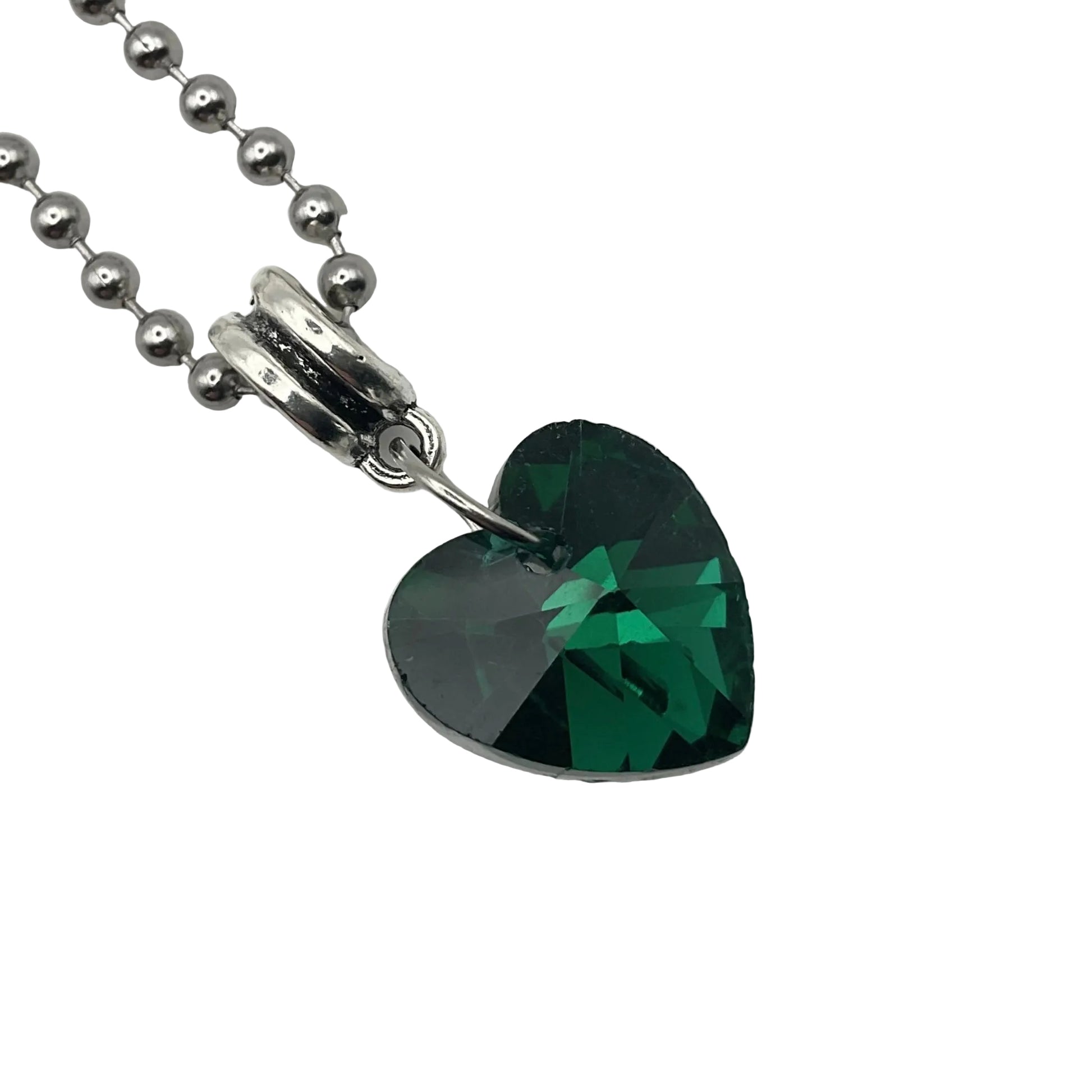 Heart-shaped green crystal pendant on a silver tone ball chain against a white background