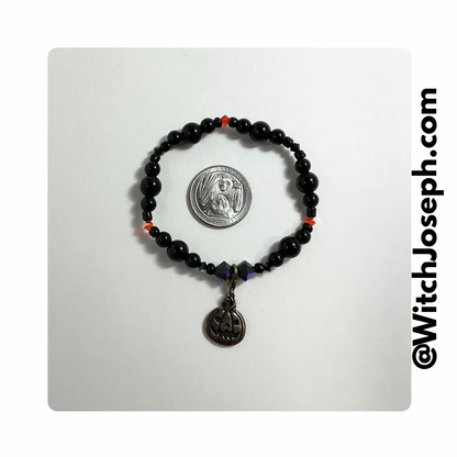 Halloween Stretch bracelet with jack o lantern displayed against a white background with the WItch Joseph url
