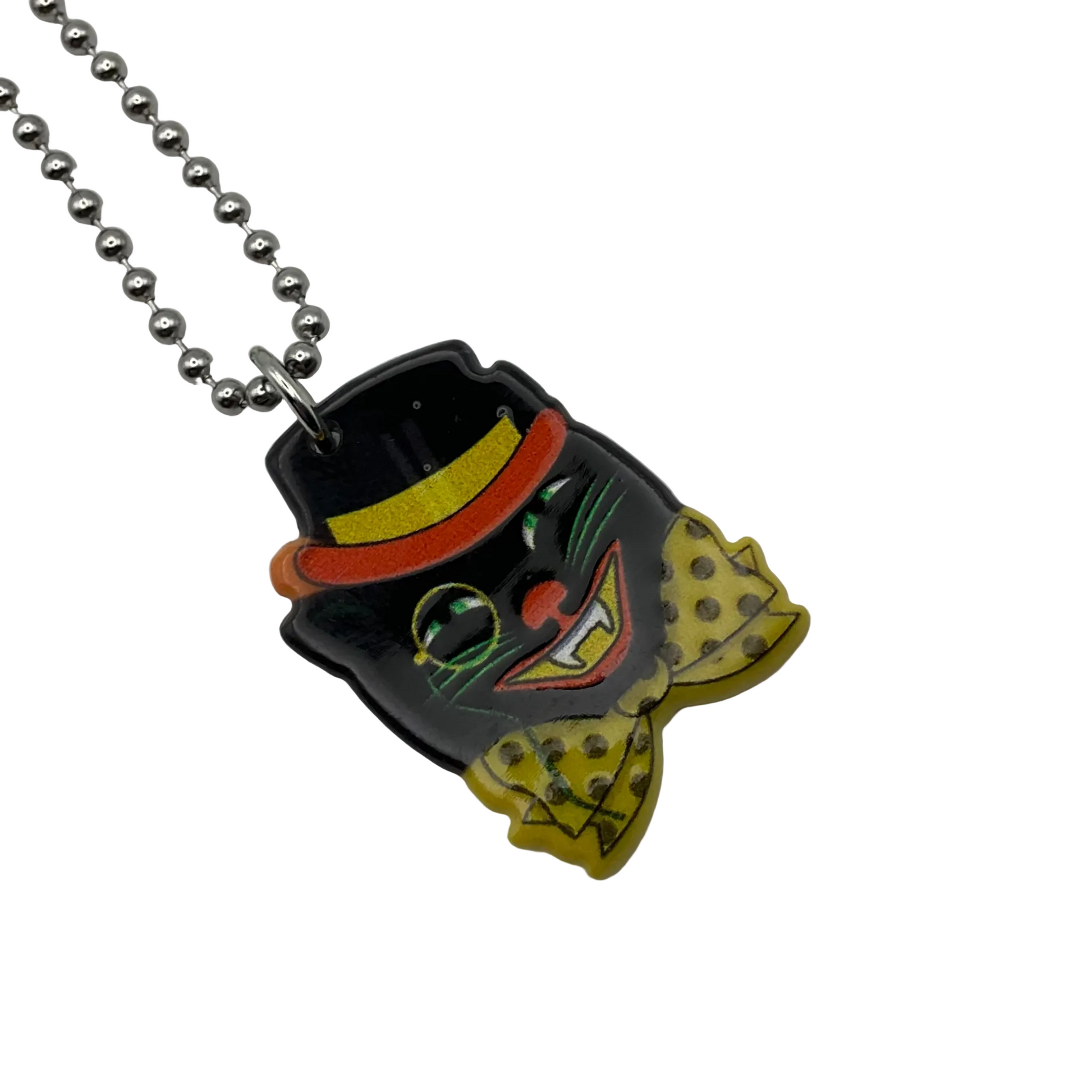 Colorful vintage style cat in hat halloween pendant on a ball chain against a white background
