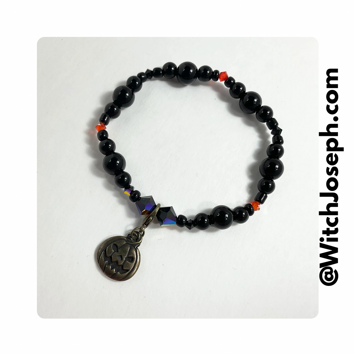 Jack-o-Lantern halloween stretch bracelet displayed against a white background with the Witch Joseph URL