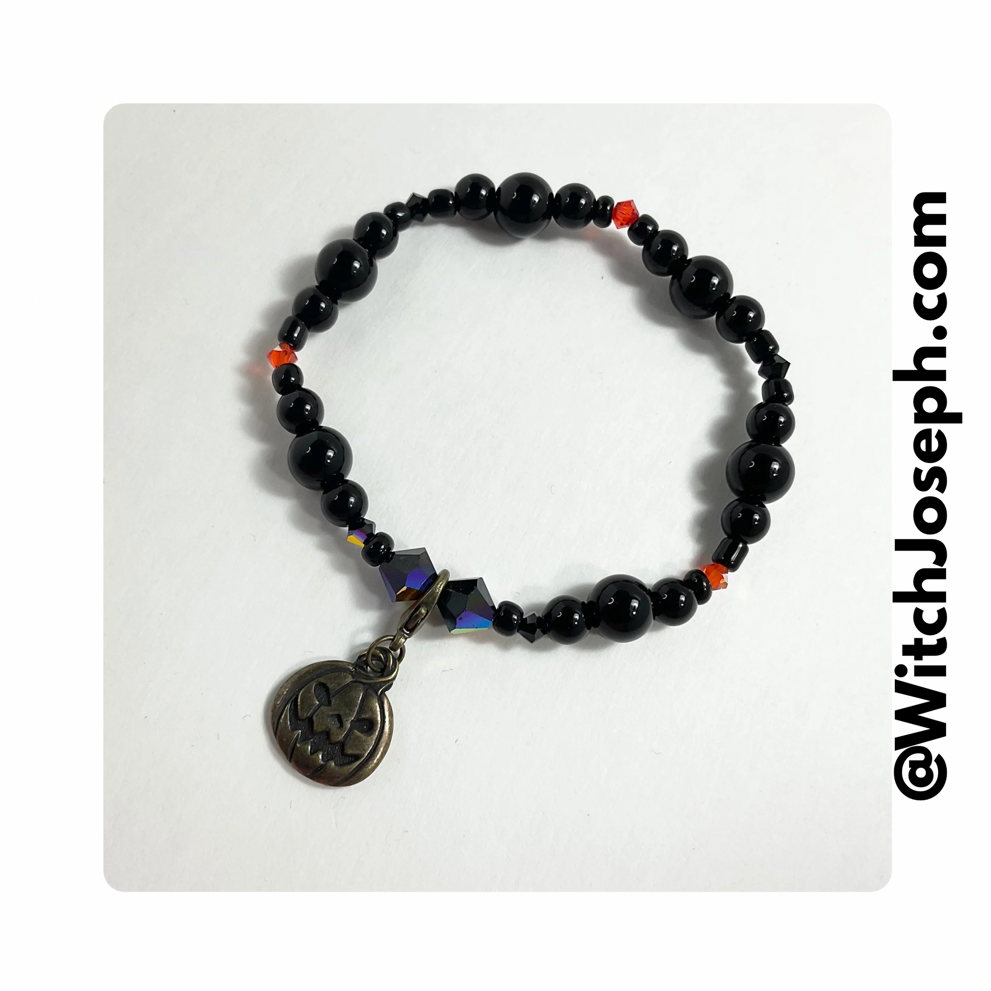 Jack-o-Lantern halloween stretch bracelet displayed against a white background with the Witch Joseph URL