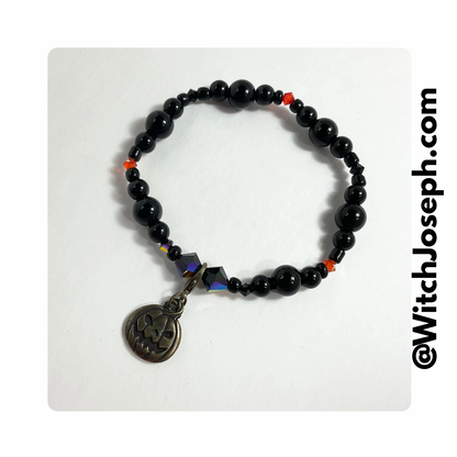 Jack-o-Lantern halloween stretch bracelet displayed against a white background with the Witch Joseph URL