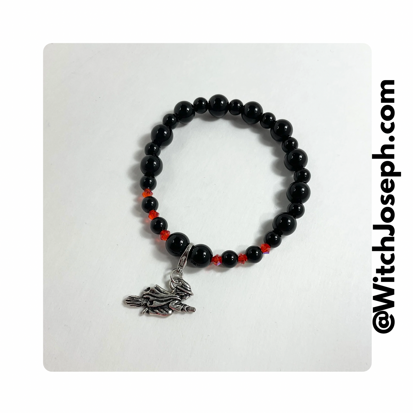 Halloween Witch halloween stretch charm bracelet with black and orange beads displayed against a light background with the Witch Joseph URL