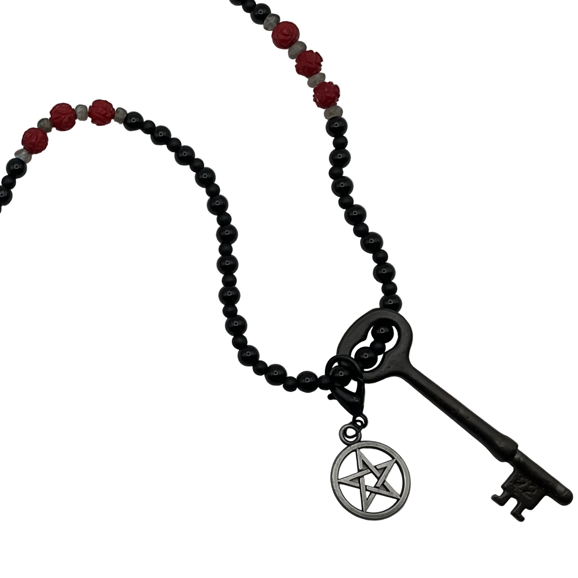 Hekate Necklace with black beads, red coral stones, and a vintage key pendant with pentacle on a white background