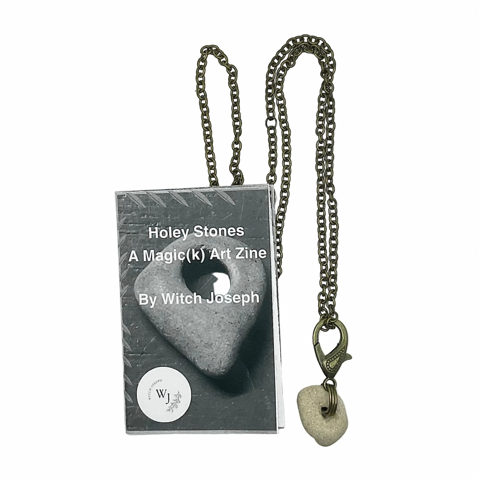 Bronze tone Necklace with Holey Stone pendant next to a zine titled 'Holey Stones' by Witch Joseph on a white background