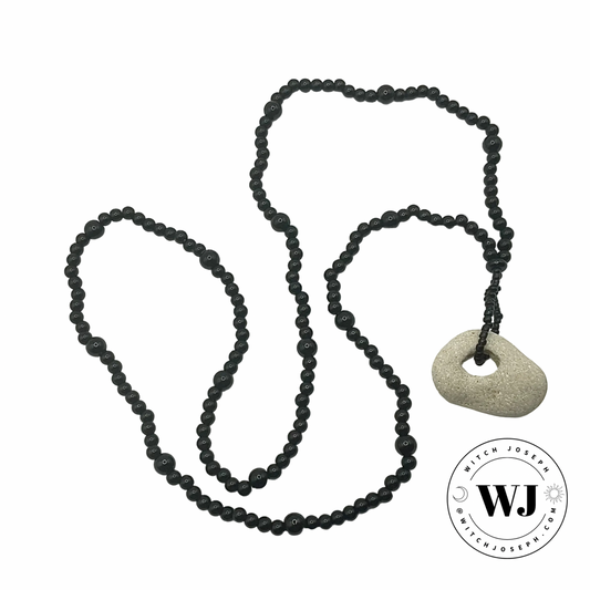 Black beaded necklace with a Holey stone pendant displayed on a white background, featuring the WJ logo.