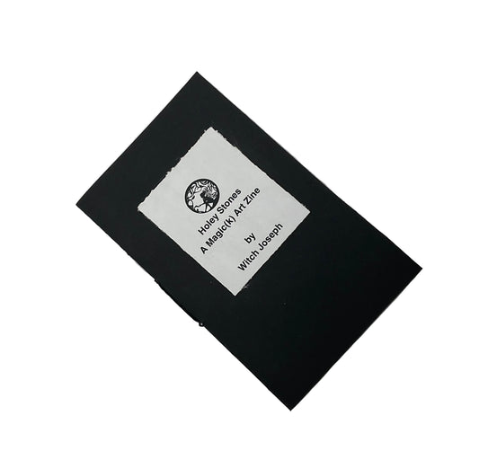 Black covered Zine with a white label with text that says “Holey Stones a Magick Art Zine by Witch Joseph” displayed on a white background