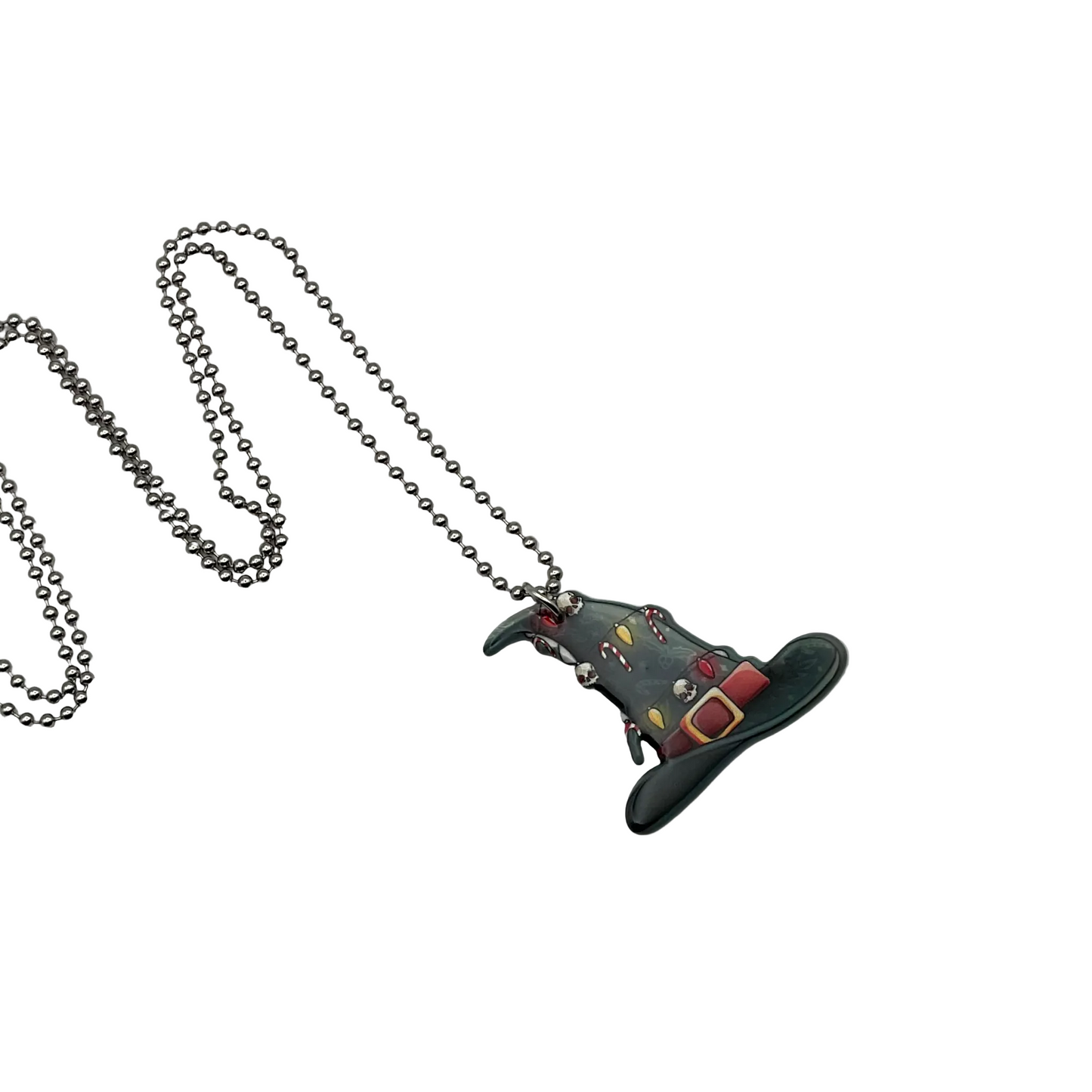 Black witch hat with candy canes and xmas lights and skulls pendant on a ball chain against a white background