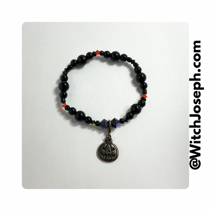 Jack o Lantern stretch bracelet displayed against a light background with the Witch Joseph URL