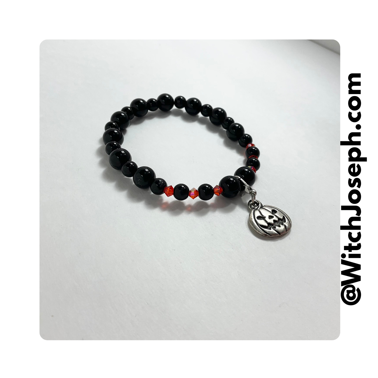 Jack o Lantern stretch bracelet shown against a white background with the Witch Joseph URL