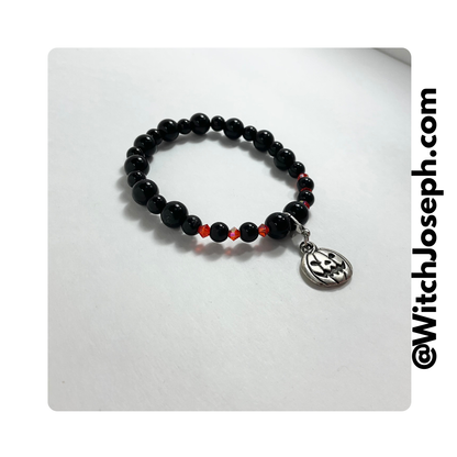 Jack o Lantern stretch bracelet shown against a white background with the Witch Joseph URL