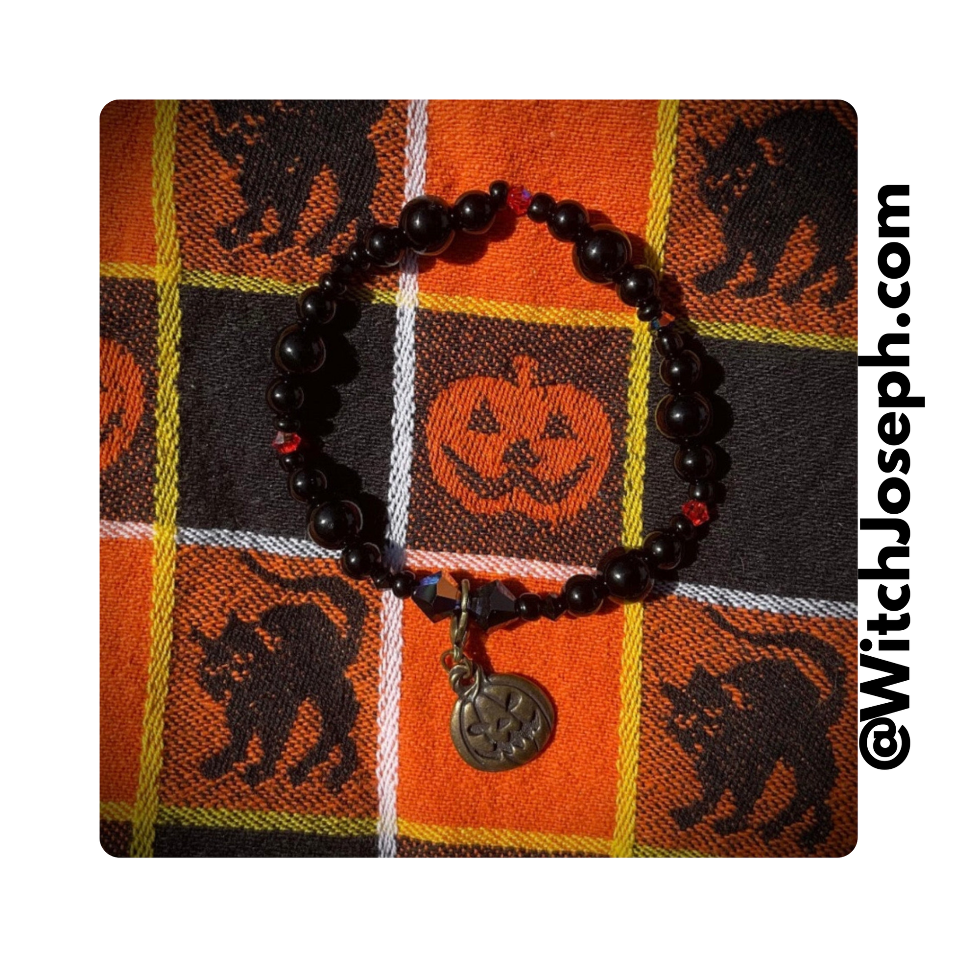 Jack o Lantern stretch bracelet displayed on vintage style halloween fabric
