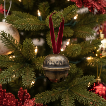 Decorative bell ornament with 'Krampus' text on a Christmas tree.
