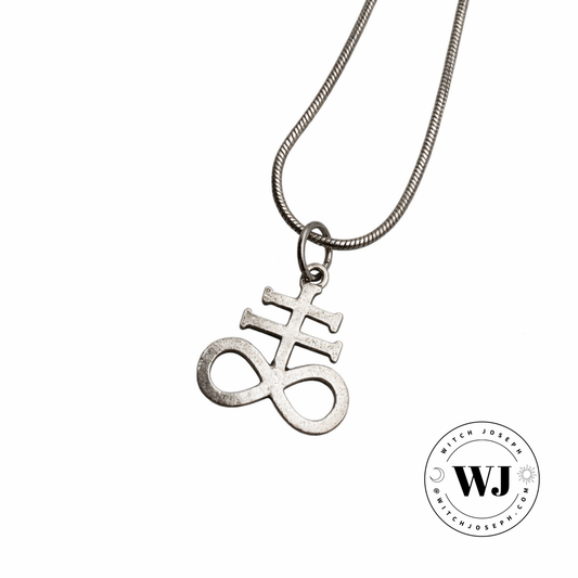 Silver tone necklace with a Leviathan cross pendant displayed on a white background, featuring the Witch Joseph logo