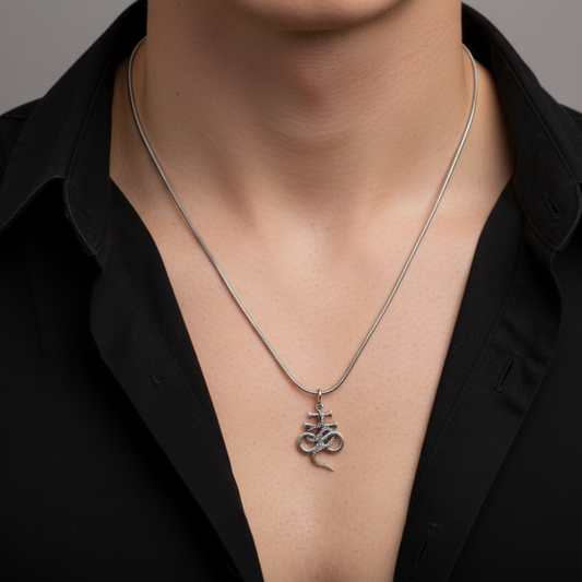 Silver necklace with a Leviathan cross with serpent pendant worn by a person in a black shirt