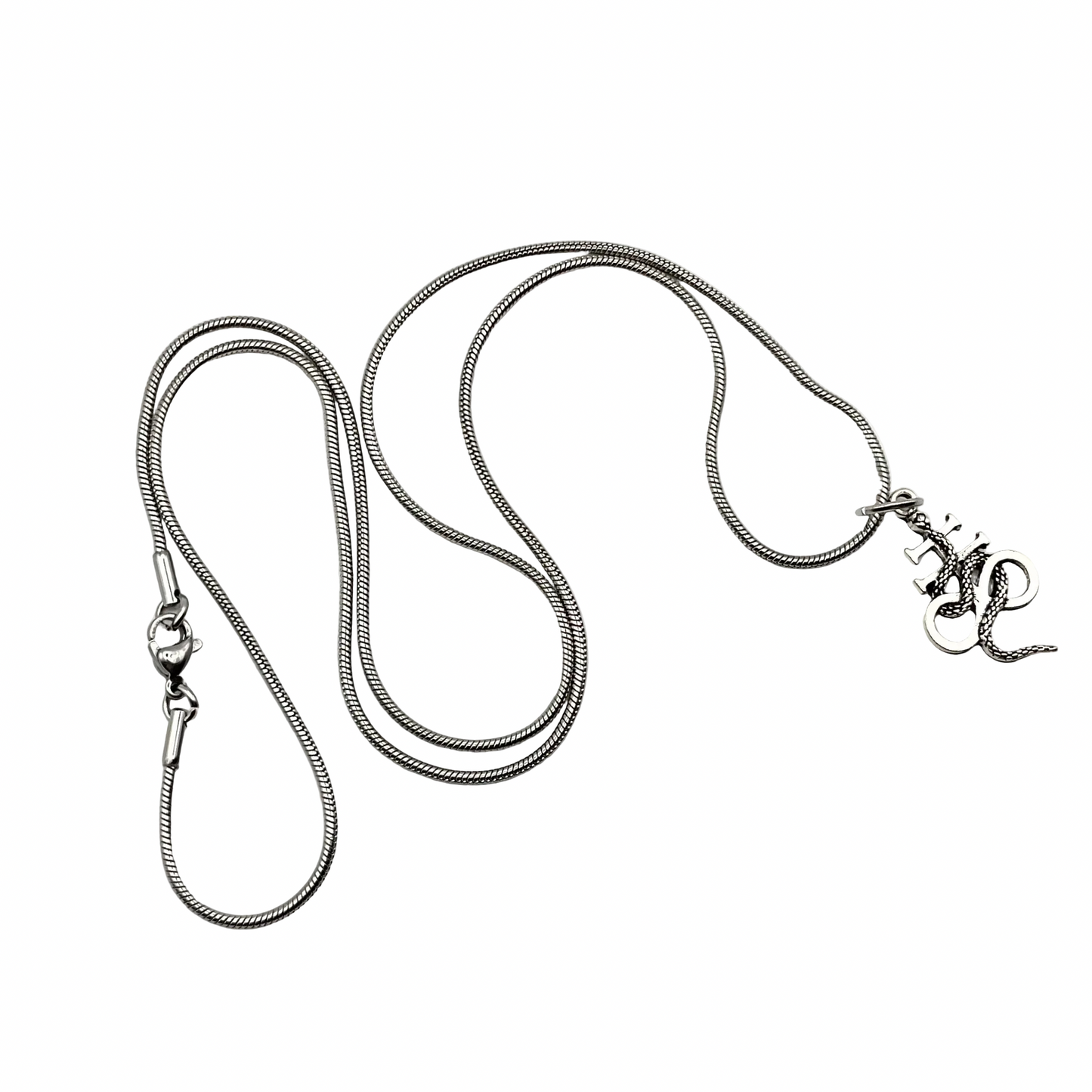 Silver tone necklace with a Leviathan cross with snake pendant on a white background