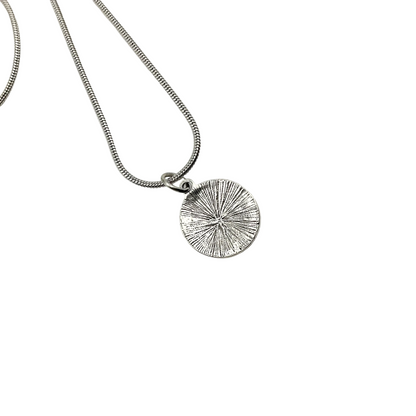 Silver tone Lilith seal necklace showing the reverse side on a white background.