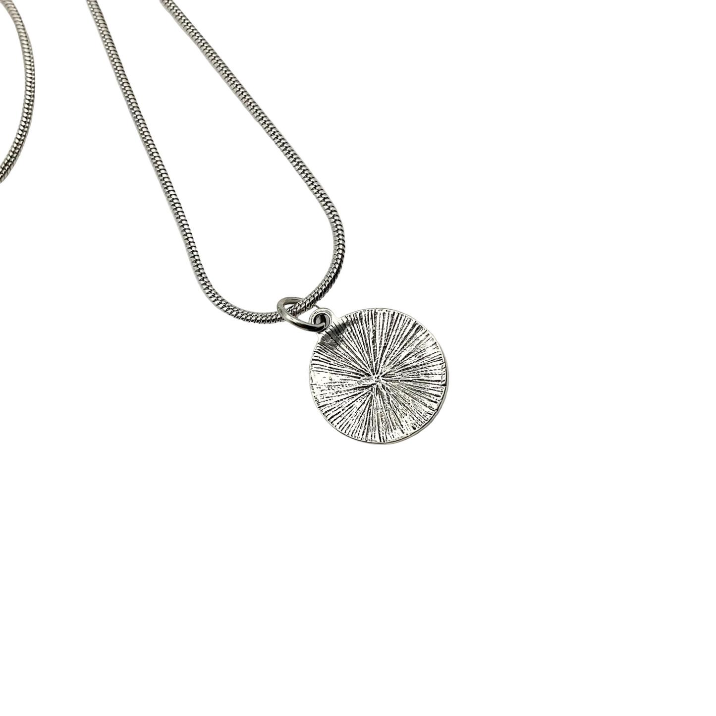 Silver necklace showing textured round reverse side of Lilith pendant on a white background