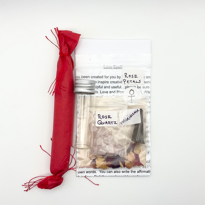 Packaged rose quartz crystals with a red ribbon on a white background