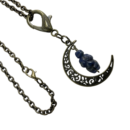 Bronze tone Necklace with a crescent moon pendant featuring a blue sodalite stone carved in a Goddess image displayed on a white background