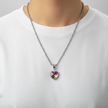 Charm Necklace being worn by a model in a white shirt…necklace features a heart-shaped multicolored crystal pendant on a white background
