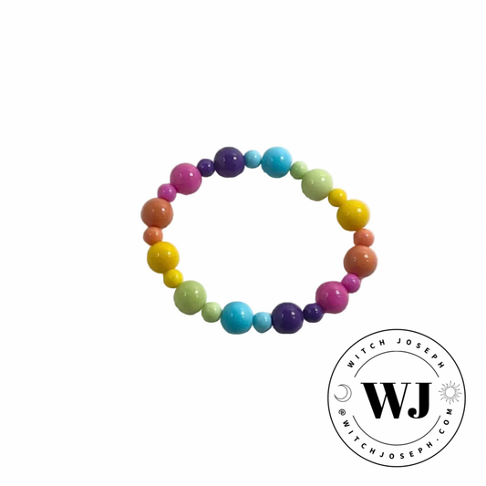 Colorful pastel pride beaded stretch bracelet displayed on a white background with WJ logo