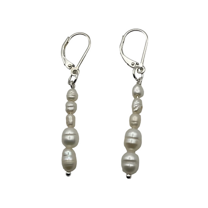 Pair of freshwater dangle pearl sterling silver earrings on a white background