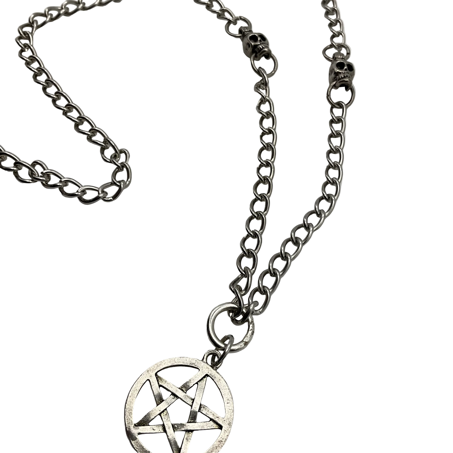 Silver tone chain necklace with a pentacle pendant with skull beads on a white background